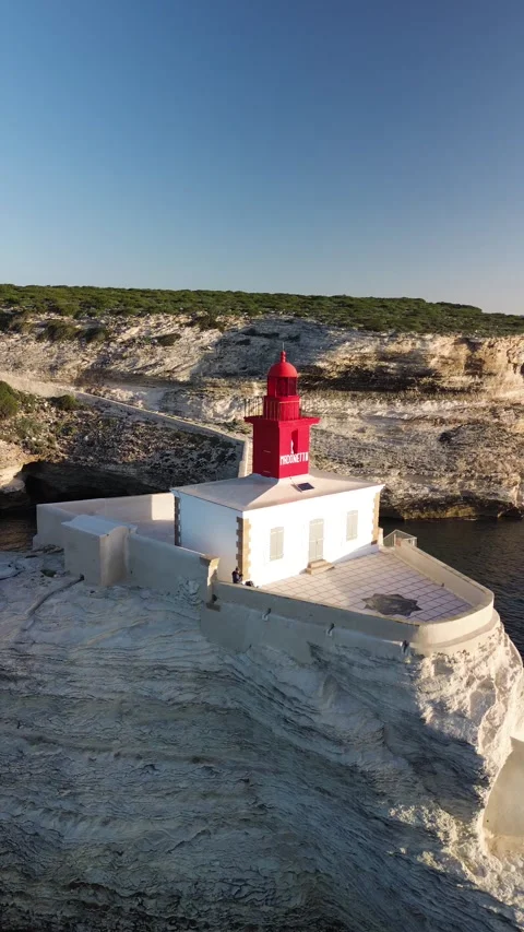 Vertical 4K Aerial Shot of a Lighthouse at Sunrise Stock Footage 331654833