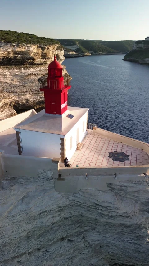 Vertical 4K Aerial Shot of a Lighthouse at Sunrise Video stock 331654846