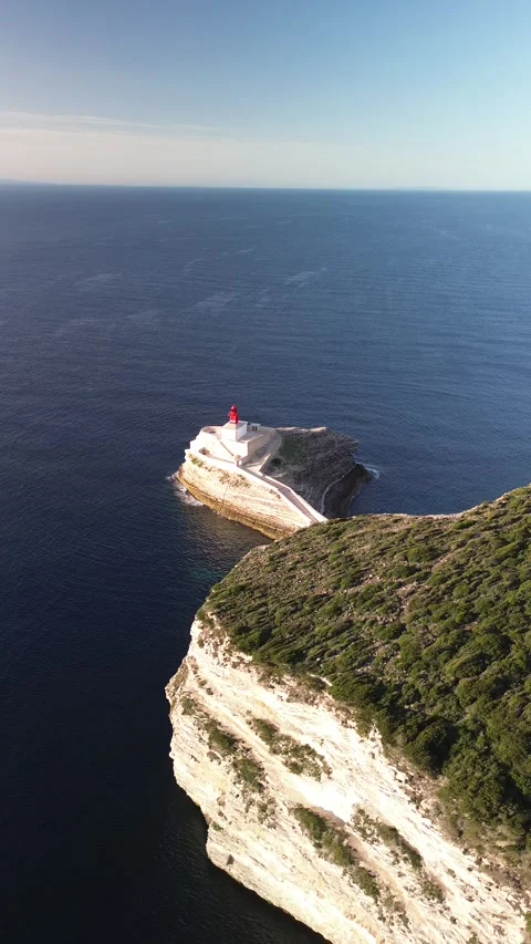 Vertical 4K Aerial Shot of a Lighthouse at Sunrise Stock Footage 331654889