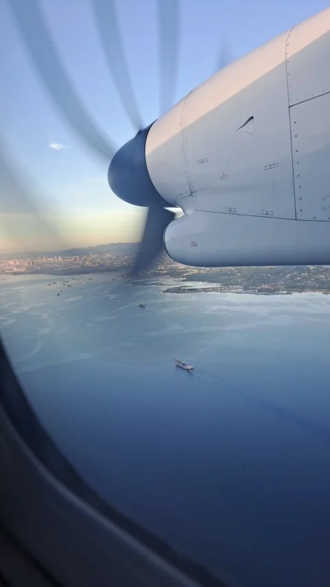 Vertical 4K of airplane window view seat above Cebu Island near landing. Stock Footage 273190023