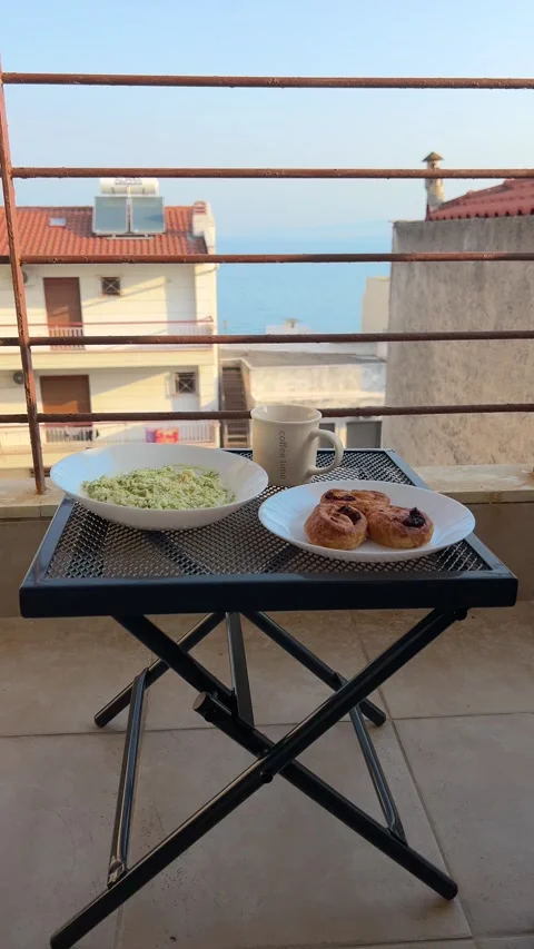 Vertical 4K Balcony Breakfast With Sea View Over Perea Rooftops, Greece Vídeo Stock 345994757