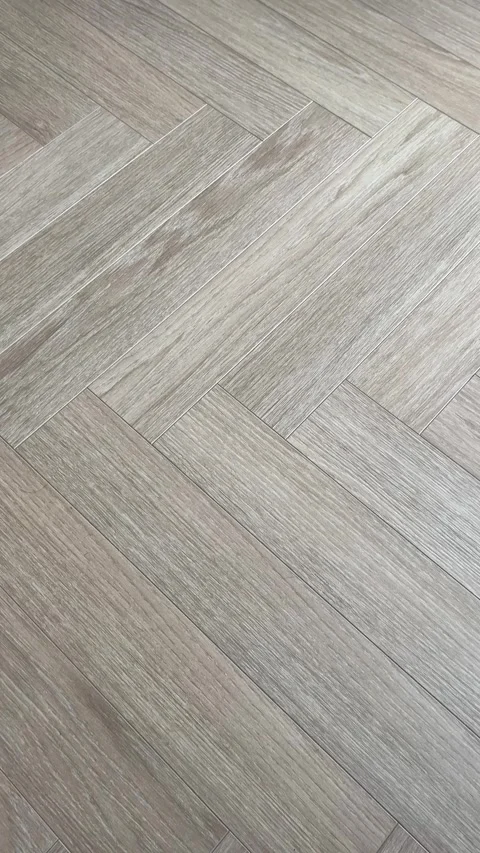 Vertical 4K - Camera Movement Over Grey Beige Oak Herringbone Parquet Floor Stock Footage 345431531