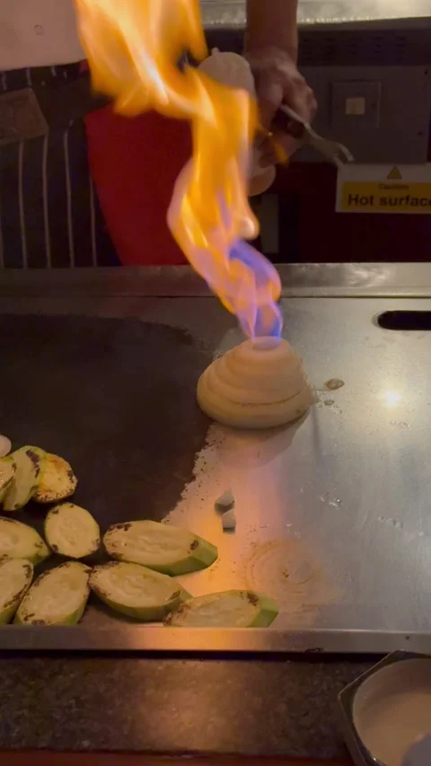 Vertical 4K Close Up Blazing Fire Burst From Teppanyaki Onion Volcano Stock Footage 335654615