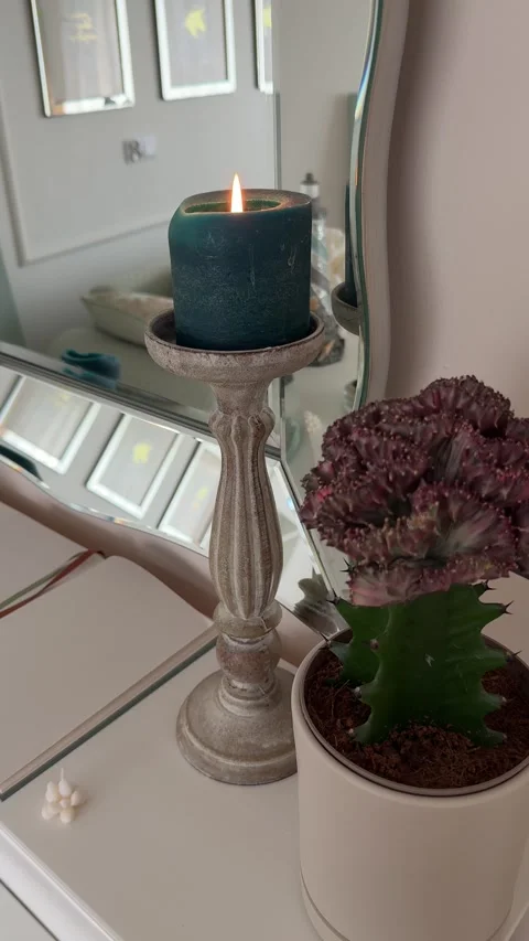 Vertical 4K - Close Up Detail Of Green Candle And Plant On Modern Mantel Stock Footage 345352497