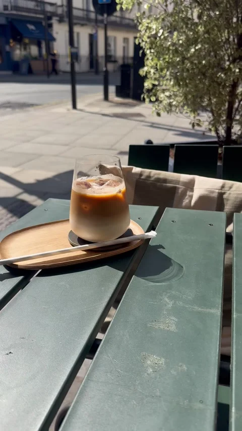 Vertical 4K Close Up Iced Latte Coffee On Cafe Outdoor Terrace Stock Footage 335779471