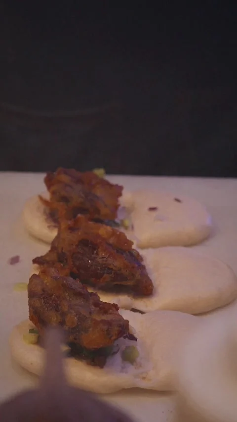 Vertical 4K close up video chef making duck bao with eel glaze Stock Footage 315990509