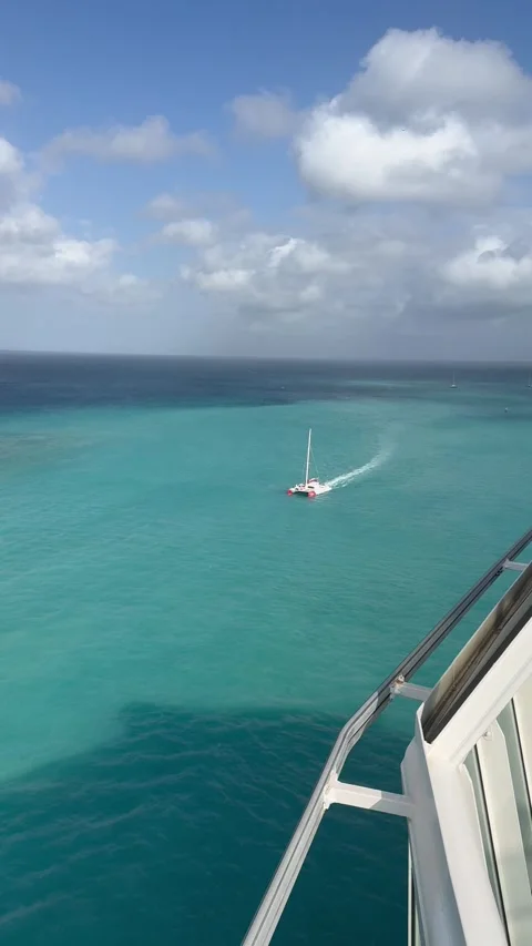 Vertical 4K Distant Catamaran Boat Sailing In Sunny Turquoise Ocean Stock Footage 335373390