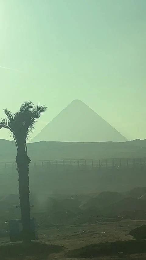 Vertical 4K: Distant View of the Pyramid of Giza from a Bus Window, Egypt Stock Footage 309319299