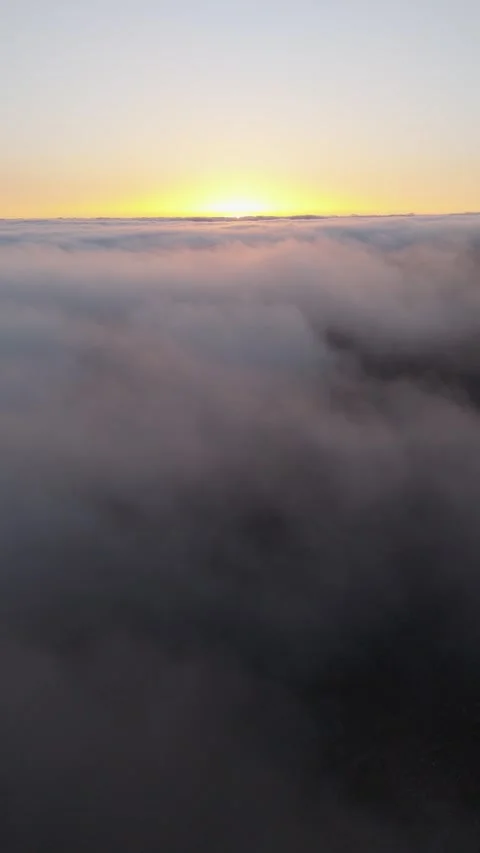 Vertical 4K Drone Flight Above Clouds at Sunset Relaxing Background 動画素材 314600563