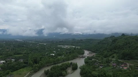 Vertical 4K drone footage of a misty Georgian village in a mountain valley a Stock Footage 343675682