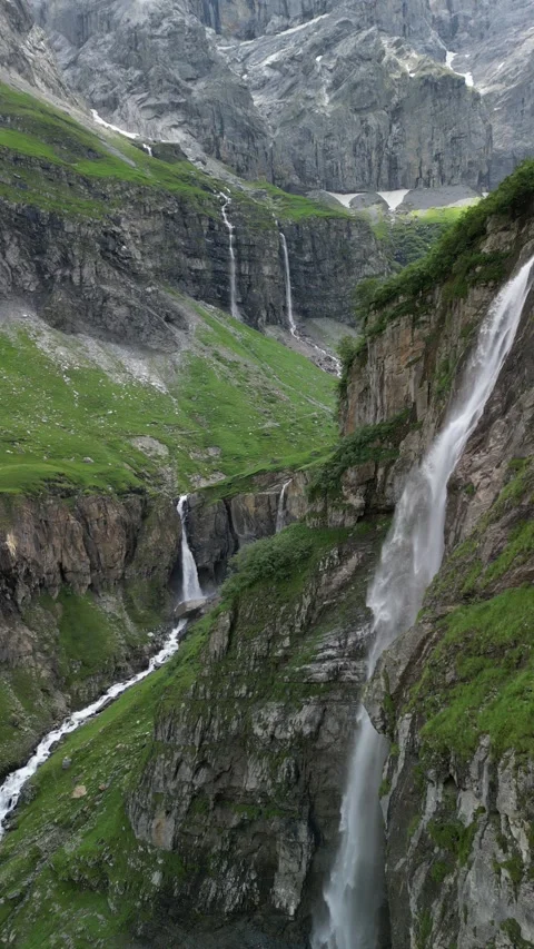 Vertical 4K Drone View of a Double Alpine Waterfall in Lush Green Video stock 328706110