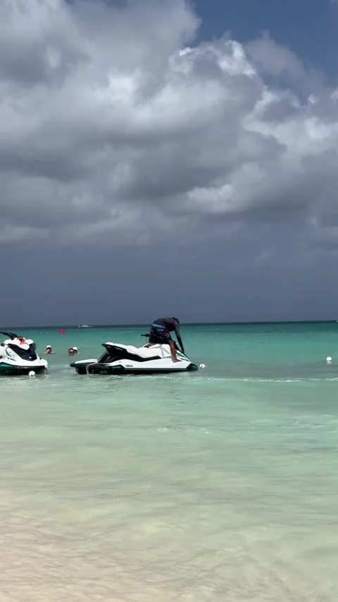Vertical 4K Editorial Man Doing Jet Ski Maneuvers Close To Aruba Beach Stock Footage 335372534