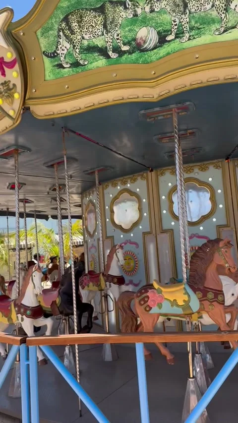 Vertical 4K Empty Vintage Carousel With Horses Spinning At Port Resort Stock Footage 335479416