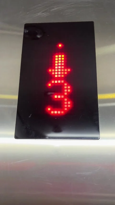 Vertical 4K Extreme Close Up of Fast Elevator Floor Numbers Decreasing Stock Footage 329263826