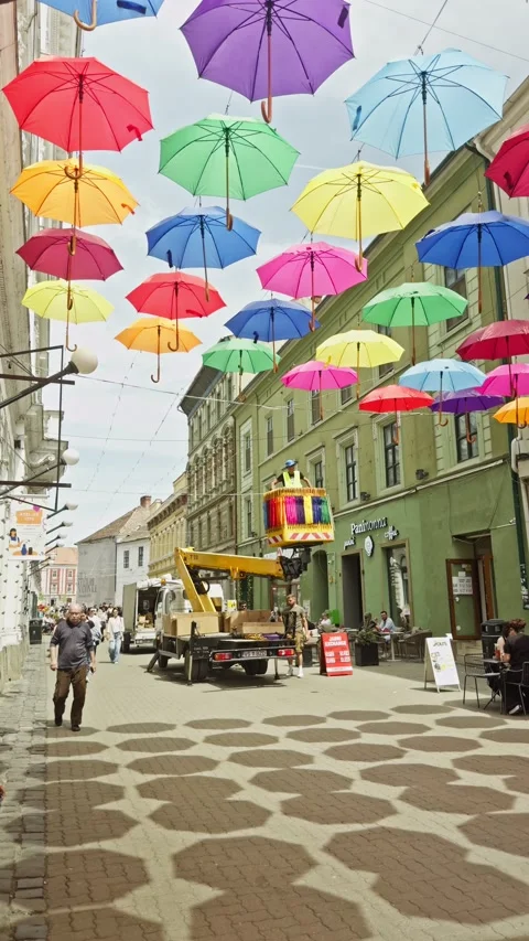 Vertical 4K footage of city workers operating a boom lift platform to install Stock Footage 339095387