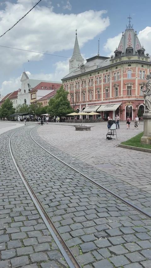 Vertical 4K footage showing old tramway tracks curving through a historic Stock Footage 336723397