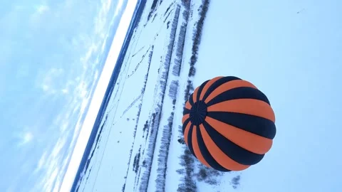 Vertical 4k FPV Drone Shot of Hot Air Balloon Above Snow Capped Land, Stock Footage 195107542