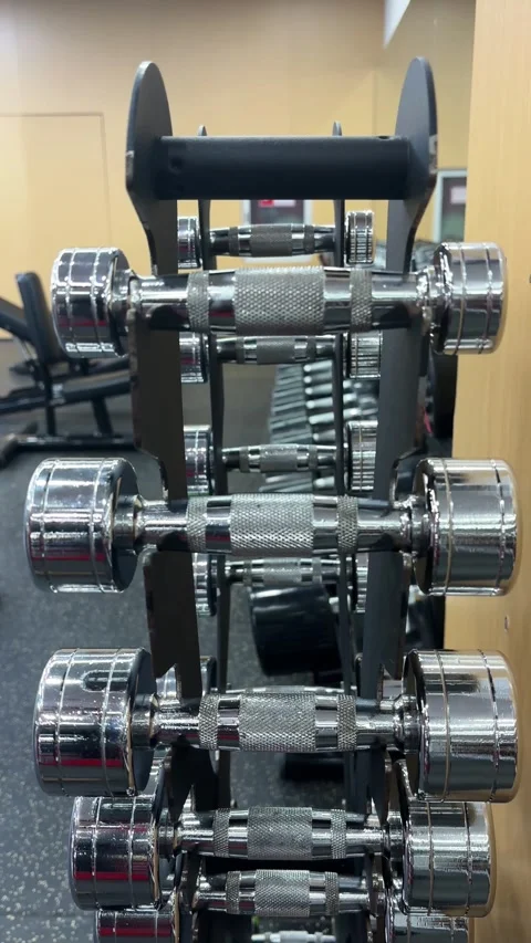 Vertical 4K Hand Returning 1kg Dumbbell to Gym Rack Stock Footage 329336528