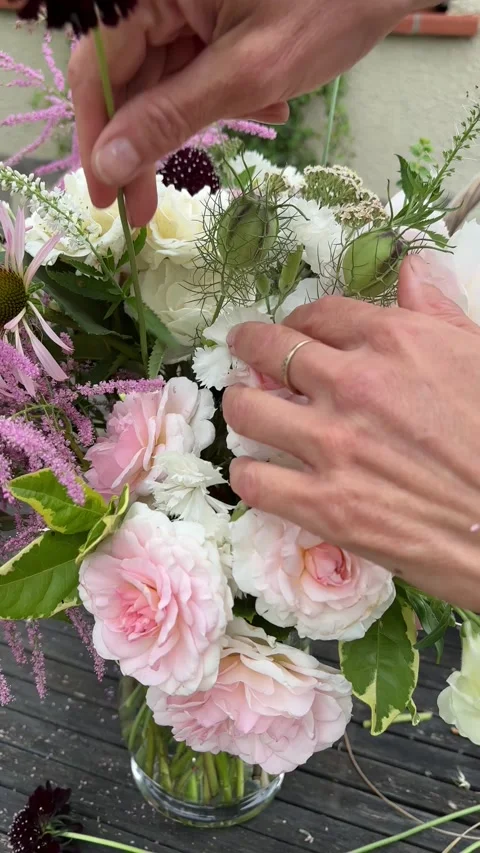 Vertical 4K handheld close up of adding scabiosa to bouquet. 스톡 동영상 337910069