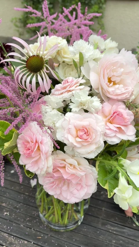 Vertical 4K handheld close up of arranging flowers in vase. 스톡 동영상 337910073