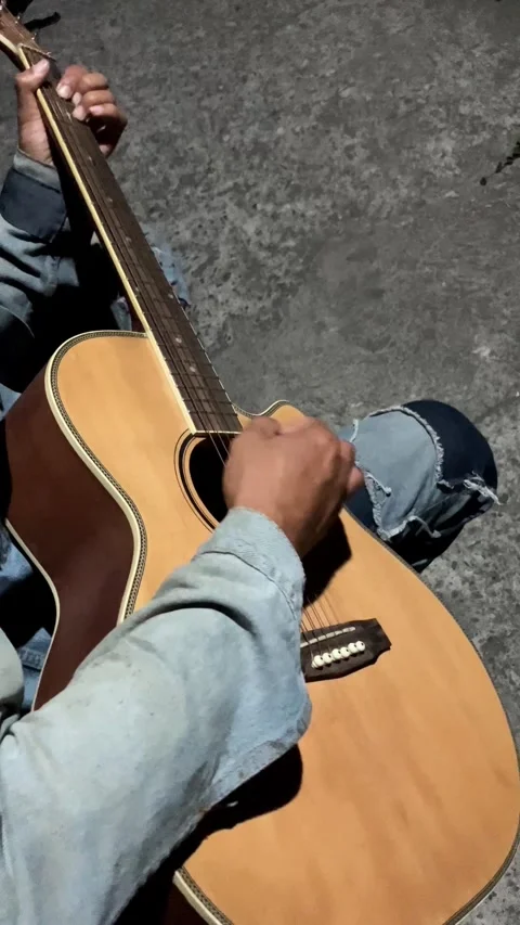 Vertical 4K High Angle View of Man Playing Acoustic Guitar at Night Stockbeeldmateriaal 337207253