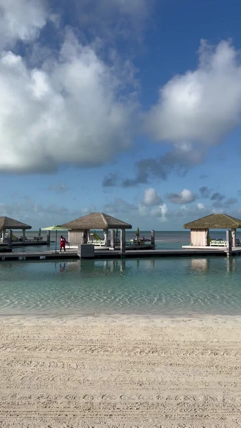 Vertical 4K Left To Right Pan Of Empty Overwater Cabanas In CocoCay Stock Footage 335549437