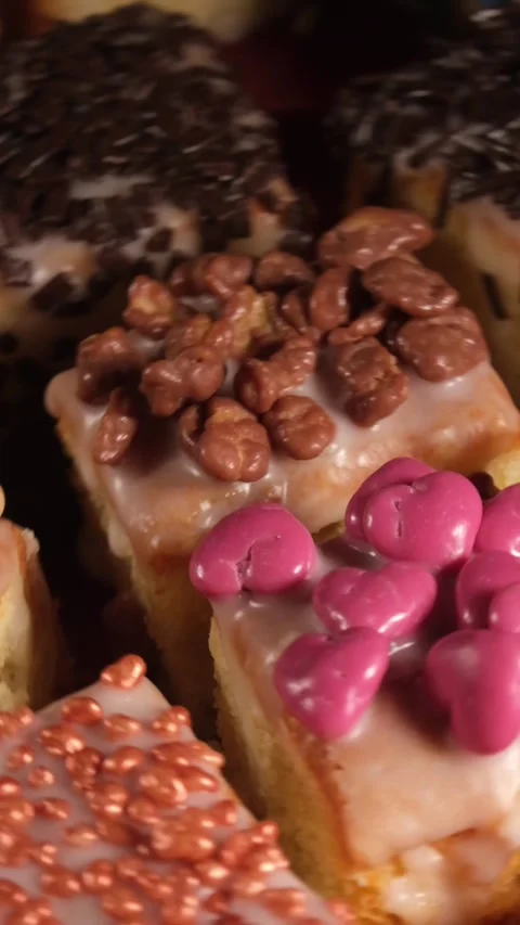 Vertical 4K Macro Close Up of Pink Heart Sprinkles on Rotating Cake Stock Footage 333319909
