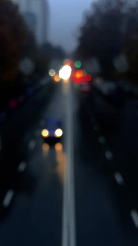 Vertical 4K night video. Blurred background. Red and white lights bokeh Stock Footage 295573849