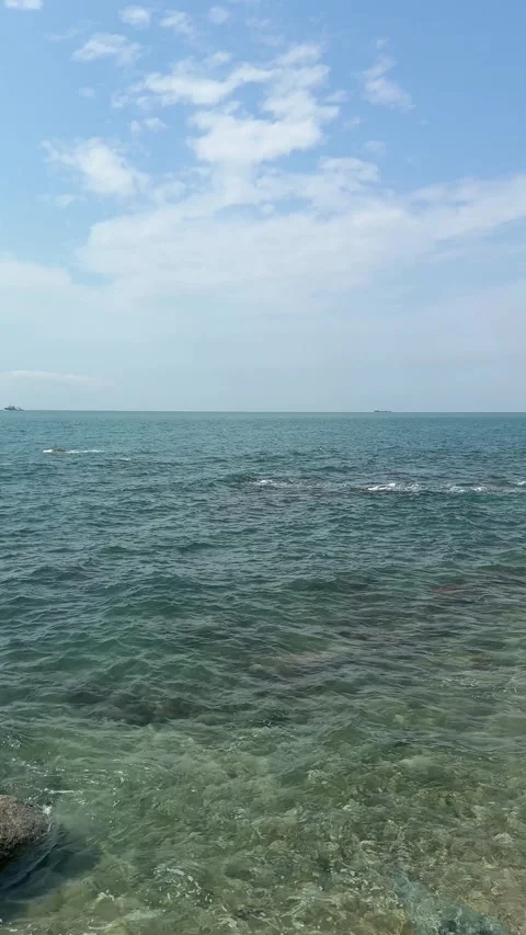 Vertical 4K Panning Shot of Ocean Waves and Rocks Stock Footage 330986935