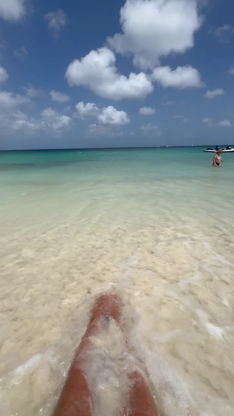 Vertical 4K POV Ocean Wave Washing Wet Sand Over Legs On Tropical Beach Stock Footage 335372576