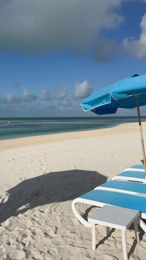 Vertical 4K POV Static View Of Sunbeds Panning To Wide Ocean Horizon Stock Footage 335549196