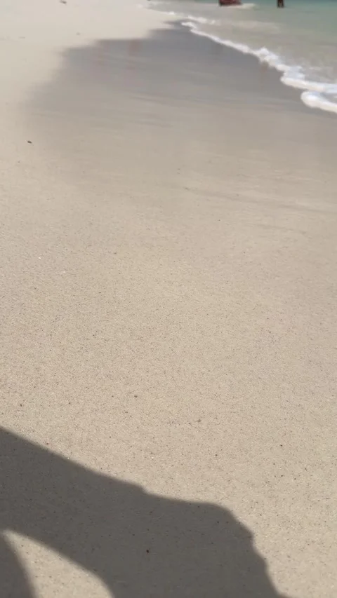 Vertical 4K POV Tilting Down From Sunny Tropical Beach To Wet Sand And Waves Vídeos de archivo 335372545