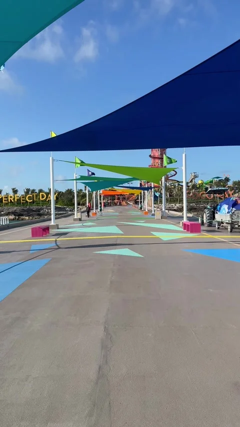 Vertical 4K POV Walking Down Empty Cruise Pier With Colorful Flags At CocoCay Vídeos de archivo 335549459