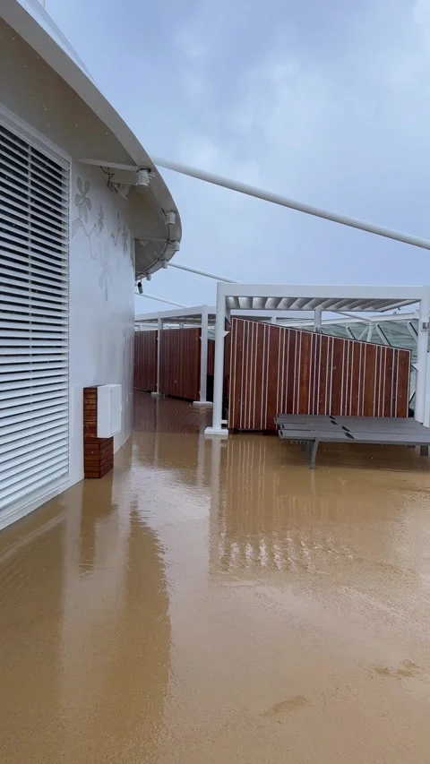 Vertical 4K Rain Pours On Empty Cruise Ship Open Upper Deck With Sun Loungers Stock-Footage 335474723