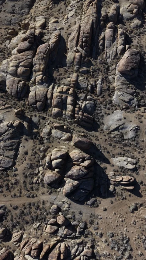 Vertical 4K Real-Time Drone Descending to Man Sitting on Rock Alabama Hills Stock Footage 324299698