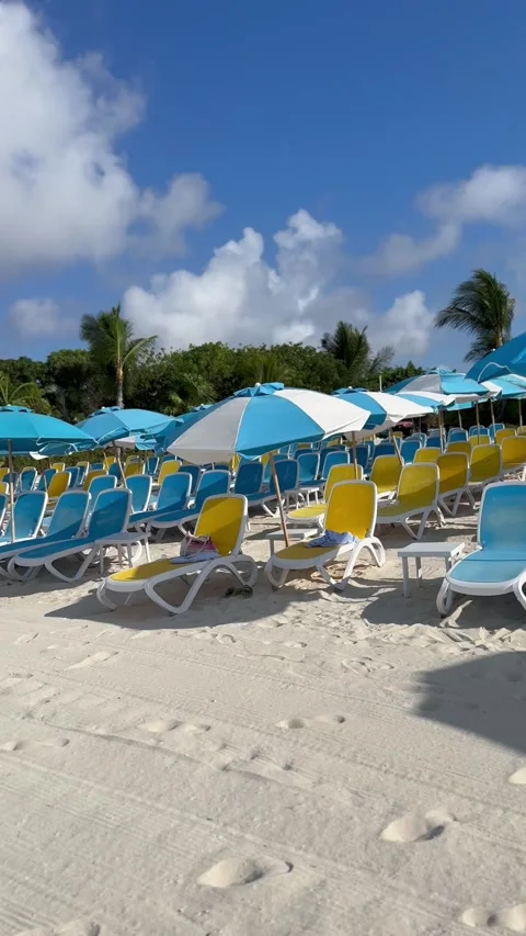 Vertical 4K Right To Left Pan Of Colorful Sun Loungers On Tropical Beach Stock-Footage 335549182