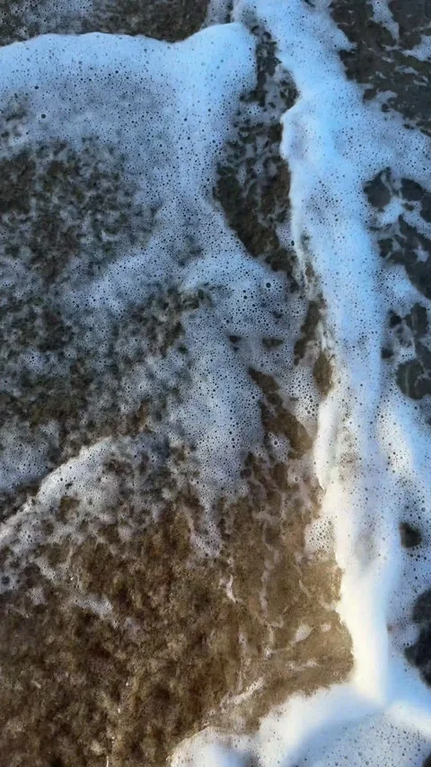 Vertical 4K Slow Motion Tide Washing Over Footprints on Tropical Beach Stock Footage 332041040