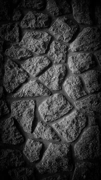 Vertical 4K stone wall background in monochrome, featuring a grainy texture.. Foto stock