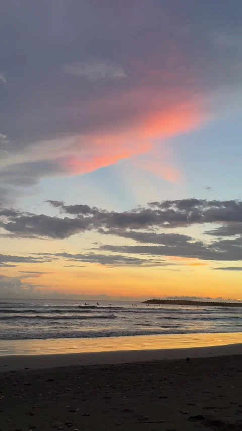 Vertical 4K Sunset Waves and Surfers on Tainan Yuguang Island Beach Stock Footage 317221222