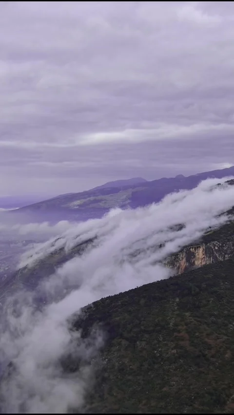 Vertical 4K Time-Lapse Showing Cinematic Clouds Flowing Rapidly Over Stock Footage 332000229
