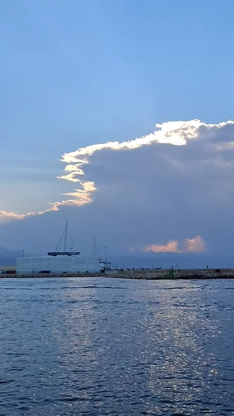 Vertical 4K timelapse of a dramatic storm cloud rising over Denia port, yach Stock Footage 340044288