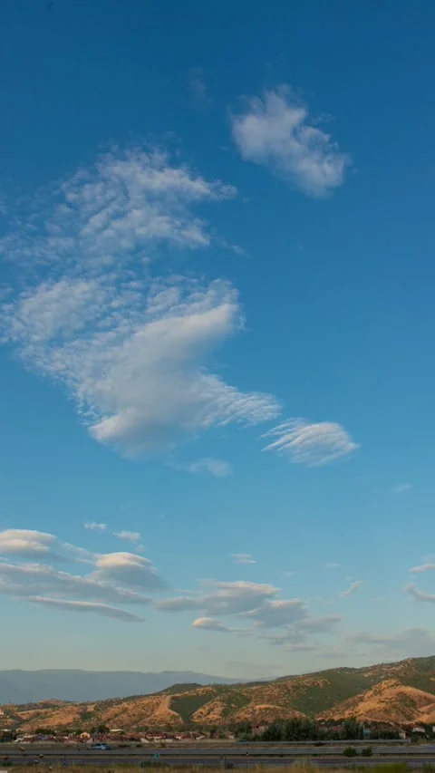 Vertical 4K timelapse of white clouds moving over mountains Stock Footage 338254186
