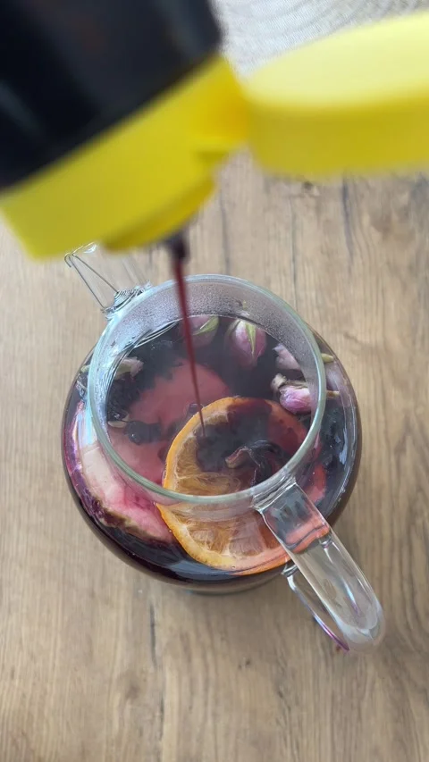 Vertical 4K Top Down Squeezing Date Syrup into Glass Teapot Winter Tea B-Roll⁠ Video stock 347098257