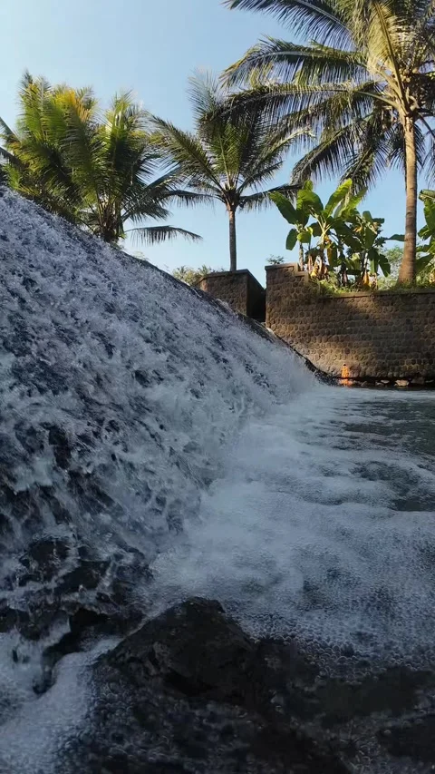 Vertical 4K Tropical Waterfall Slope with Palm Trees and White Water Flow Stock Footage 337158382