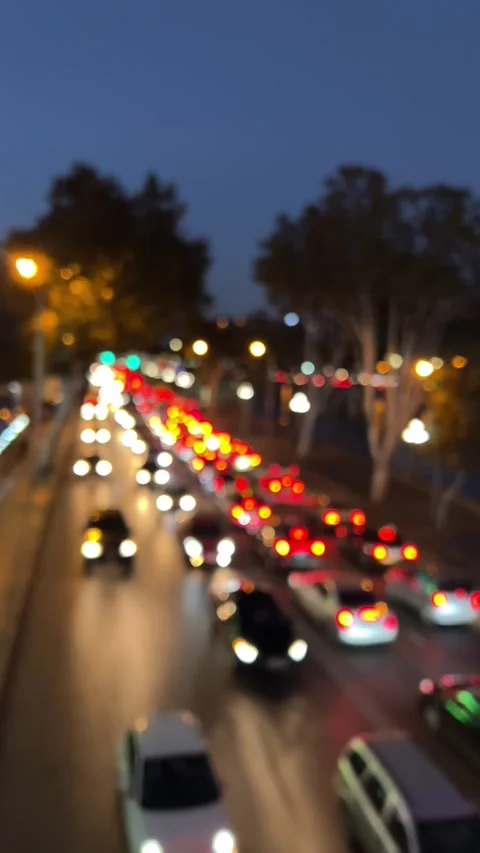 Vertical 4K video. Blurred background. Flow of cars on road at night Stock Footage 255915731