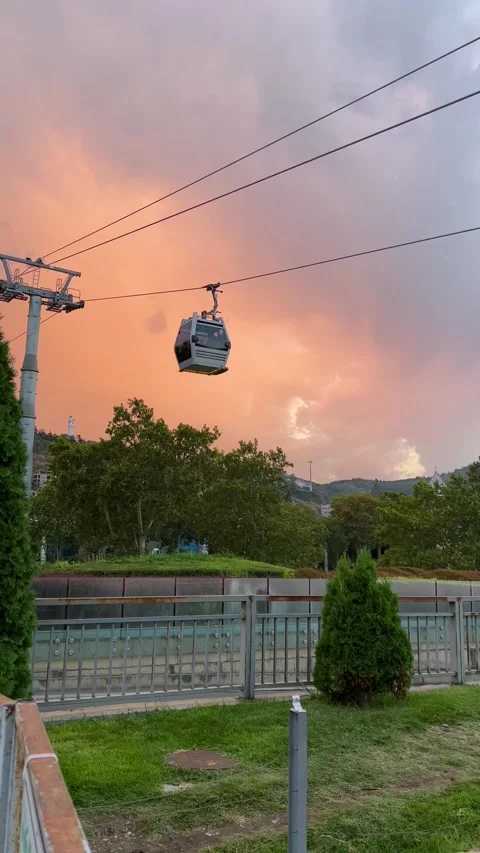 Vertical 4K video. Cable car cabin rides on rope at sunset Stock Footage 333273279