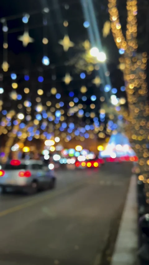 Vertical 4K video. City decor, garland glow, cars flow out of focus on road Stockbeeldmateriaal 340427966