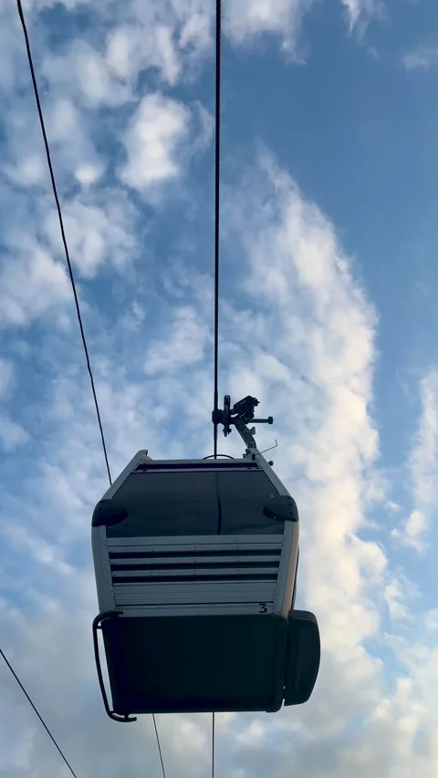 Vertical 4K video close up. Bottom view of cable car cabin rides on rope Vidéo 341275243
