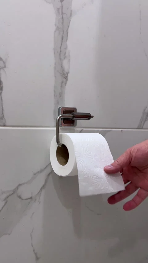 Vertical 4K video. Man tears off piece of white toilet paper Stock Footage 300251205