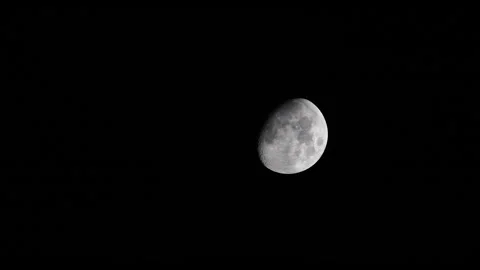 Vertical 4K video of the moon in night sky with clouds slowly passing Stock Footage 331785392